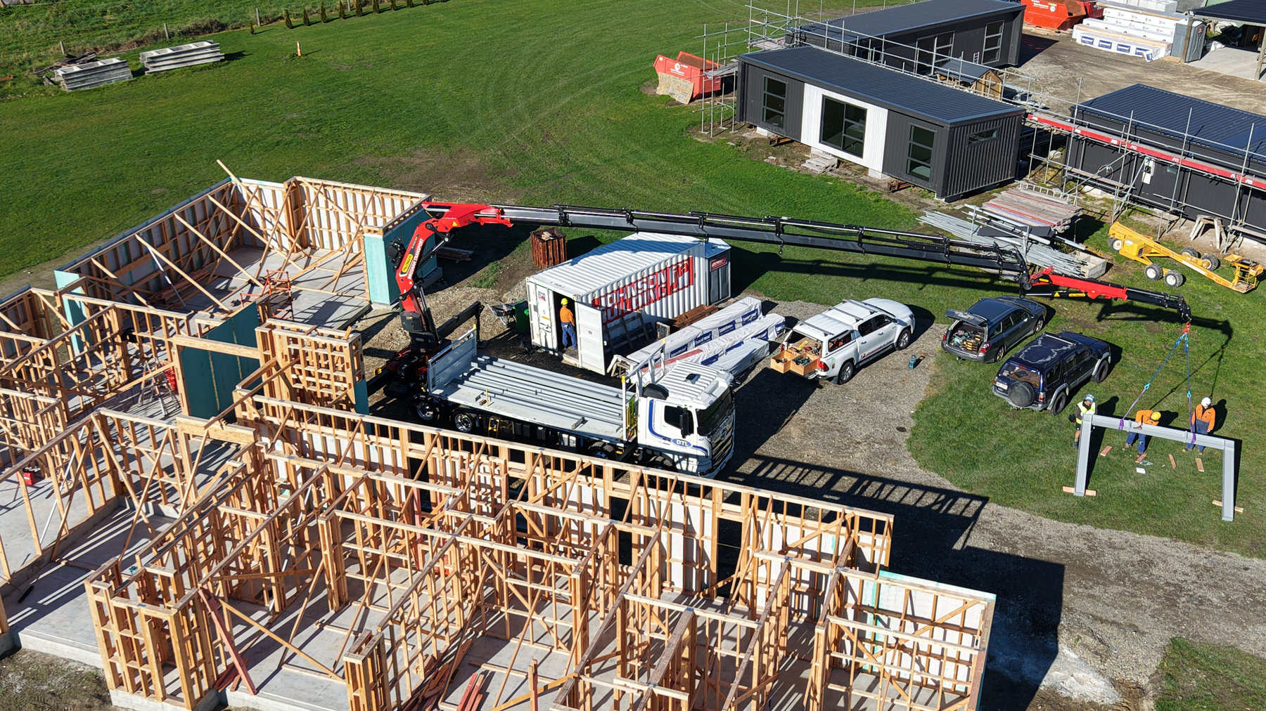 Crane working beside timber house framing